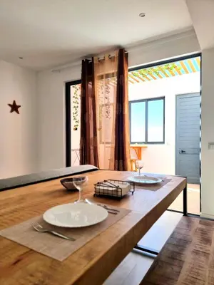 a kitchen with a wooden table with plates on it at R3 Apartments - Laginha in Mindelo