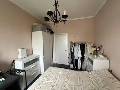 a bedroom with a bed and a chandelier at Apt Martins May 2 in Vila do Maio