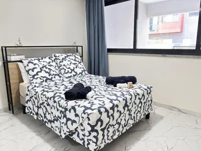 a bedroom with a bed with stuffed animals on it at Relax and Stay in Praia Spacious 3bdr Apartment in Praia