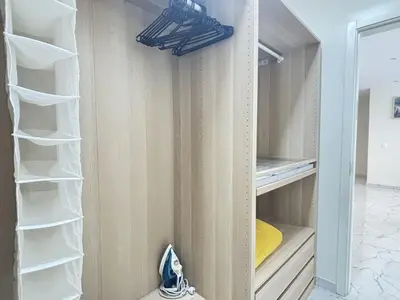 a walk in closet with white shelves at Relax and Stay in Praia Spacious 3bdr Apartment in Praia