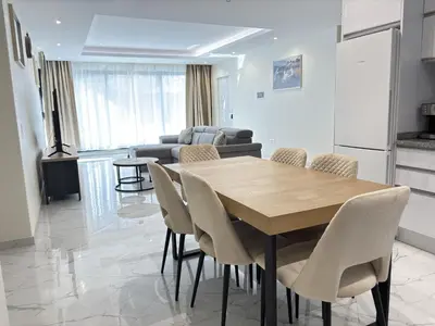 a kitchen and dining room with a table and chairs at Relax and Stay in Praia Spacious 3bdr Apartment in Praia