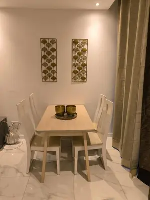 a wooden table and chairs with two bowls on it at Apartamento Praia JOIA in Praia