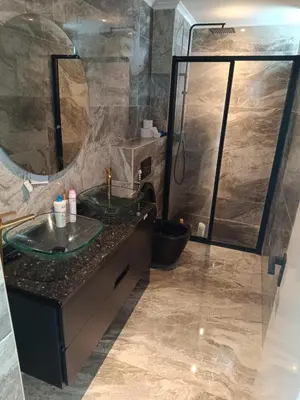 a bathroom with two sinks and a shower at Apartamento Praia JOIA in Praia