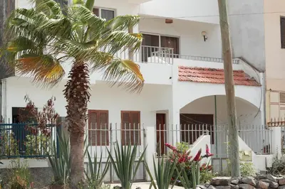 a palm tree in front of a white building at Casa Ida 2 Tarrafal, Santiago, Cape verde in Tarrafal