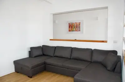 a living room with a gray couch in a room at Beautiful Penthouse in Sal Rei