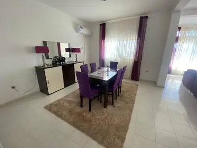 a dining room with a table and purple chairs at Casa Ramanda in Tarrafal