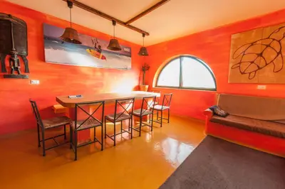 a dining room with a table and chairs and a window at Surfactivity Guest House in Santa Maria