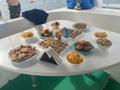 a table filled with different types of pastries and desserts at Aaparthotel Book a Taxi Group in Prainha