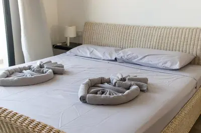 a bed with three animal shaped towels on it at Atlantic Sal Ocean View in Santa Maria