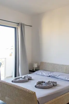 a bed with four pillows on top of it at Atlantic Sal Ocean View in Santa Maria