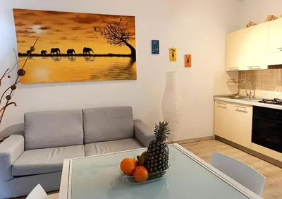 a living room with a couch and a bowl of fruit on a table at Boadream Casa Duria Porta Rossa in Prainha