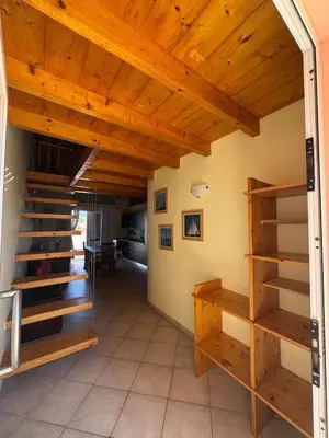 a room with wooden ceilings and wooden shelves at Holiday Properties Prestige Apartments in Santa Maria