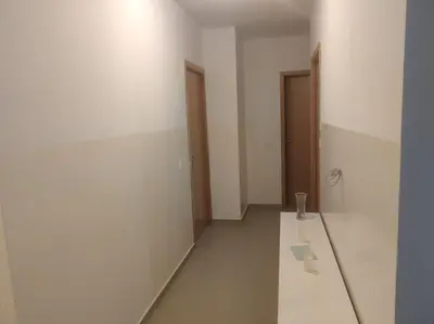 an empty room with two doors and a table at Kaza Horta in Tarrafal