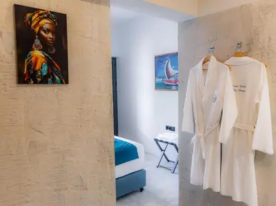a room with a wall with a picture of a woman at Boutique Hotel Luz da Lua in Ponta do Sol
