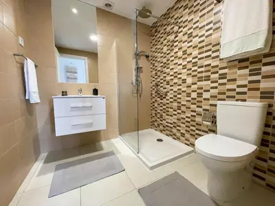 a bathroom with a toilet and a glass shower at Helena - Marel Bliss Apartments T3 in Mindelo