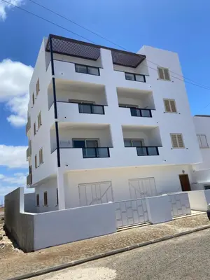 a white building on the side of a street at MaRiRa Apartments T1 in Santa Maria