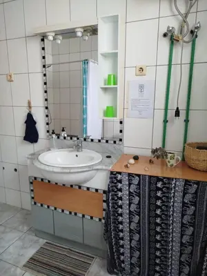 a bathroom with a sink and a mirror at Kasa Sirena in Tarrafal