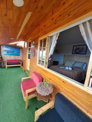 a bedroom with a bed and a couch and a table at Bangaló Buzio Relax in Portal