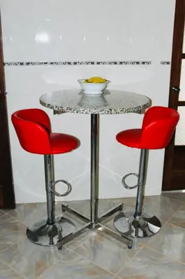 two red chairs and a table with a bowl on it at La Kaza du Soleil in Tarrafal