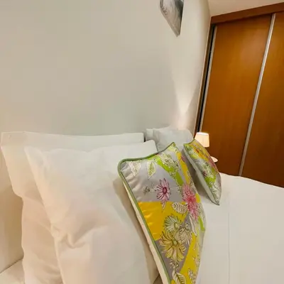 a white bed with two pillows on top of it at Sal Little Heart Bia Apartment 19 in Santa Maria