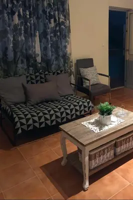 a living room with a couch and a coffee table at Casa azul in Mindelo
