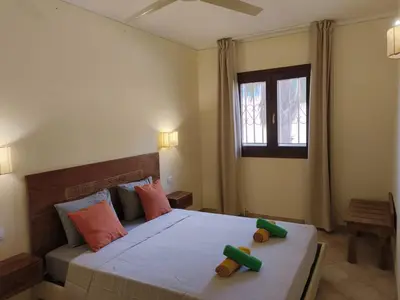 a bedroom with a bed with two toy figures on it at Marialva Tropical T2 in Santa Maria