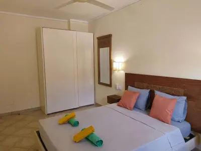 a bedroom with a bed with two toy controllers on it at Marialva Tropical T2 in Santa Maria