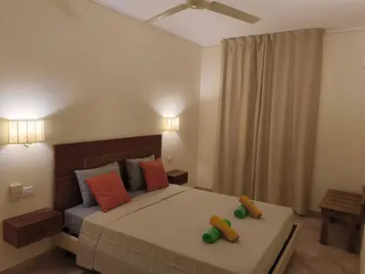 a bedroom with a bed with two toy cars on it at Marialva Tropical T2 in Santa Maria