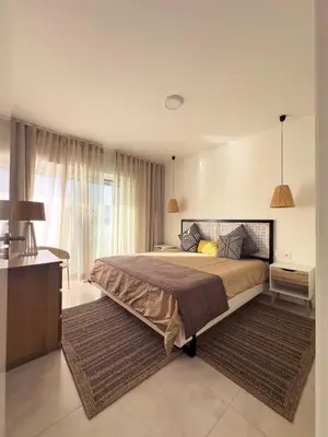 a bedroom with a large bed and a large window at Marina Mindelo Bay View in Mindelo