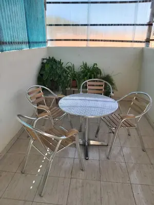 a table and two chairs sitting next to a table at Apartamentos Sossego in Praia