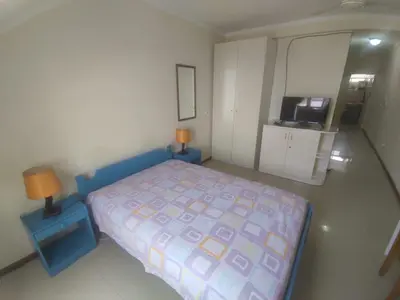 a small bedroom with a bed and a tv at Apartamentos Sossego in Praia