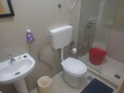 a bathroom with a toilet and a sink and a shower at Apartamentos Sossego in Praia