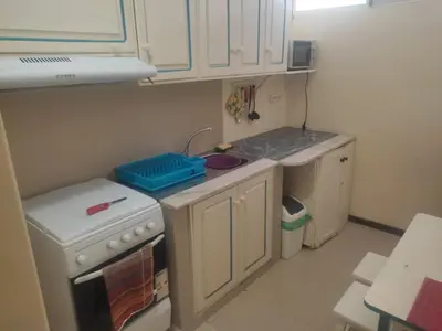 a small kitchen with a sink and a stove at Apartamentos Sossego in Praia