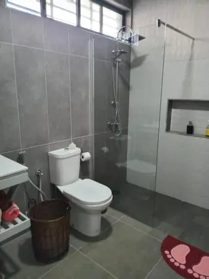 a bathroom with a toilet and a glass shower at Abraço d Mindel in Mindelo