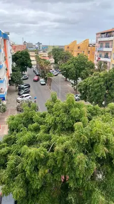 a city street with cars parked in a parking lot at Casa Fortes in Praia