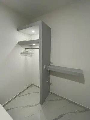 a room with a door and a shelf on the wall at Di Rosa Apartament in Praia