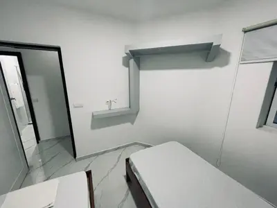 a white room with a mirror and a window at Di Rosa Apartament in Praia
