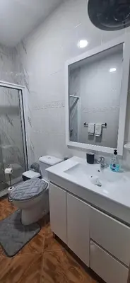 a bathroom with a toilet and a sink and a mirror at Morabeza Serena in Santa Maria