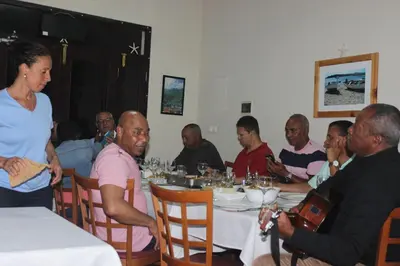 a group of people sitting around a table at Hotel POUSADA Brava in Vila Nova Sintra