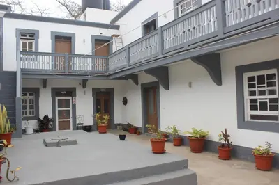 a building with a courtyard with potted plants at Hotel POUSADA Brava in Vila Nova Sintra
