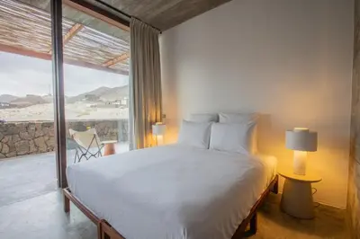 a bedroom with a large bed and a large window at Villa - Vue Mer et Piscine Privée in Mindelo