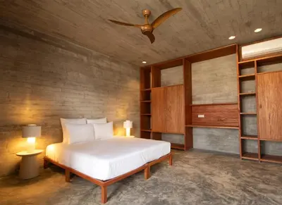 a bedroom with a bed and a ceiling fan at Villa - Vue Mer et Piscine Privée in Mindelo