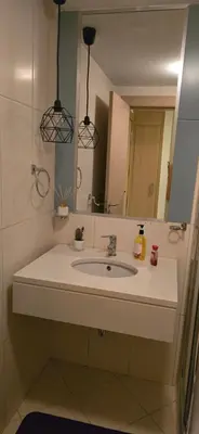 a bathroom with a sink and a mirror at Apartamento mj in Santa Maria