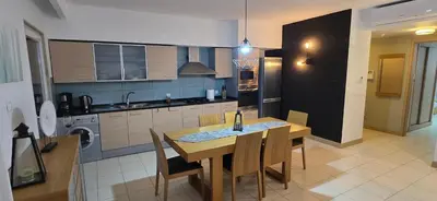 a kitchen with a wooden table and chairs in a room at Apartamento mj in Santa Maria