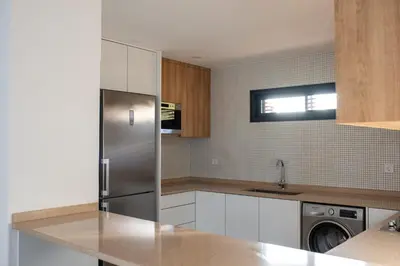 a kitchen with a stainless steel refrigerator and a dishwasher at Bordão Apartments in Praia