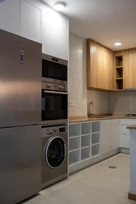 a kitchen with a washer and a dishwasher at Bordão Apartments in Praia