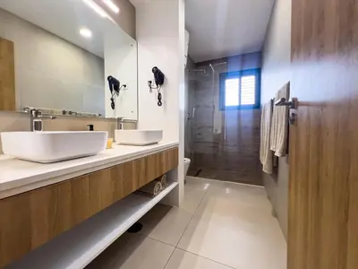 a bathroom with a white sink and a mirror at Bordão Apartments in Praia