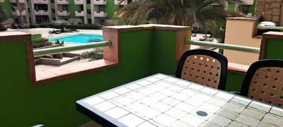 a table and chairs on a balcony with a pool at Sal service green moradias residence with pool in Santa Maria