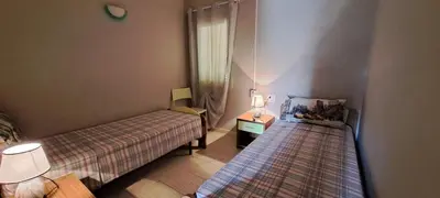 a small room with two beds and a window at Sal service green moradias residence with pool in Santa Maria