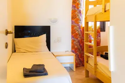 a bedroom with a bunk bed and a ladder at Aparthotel Tropical Bounty Beach L02 in Santa Maria